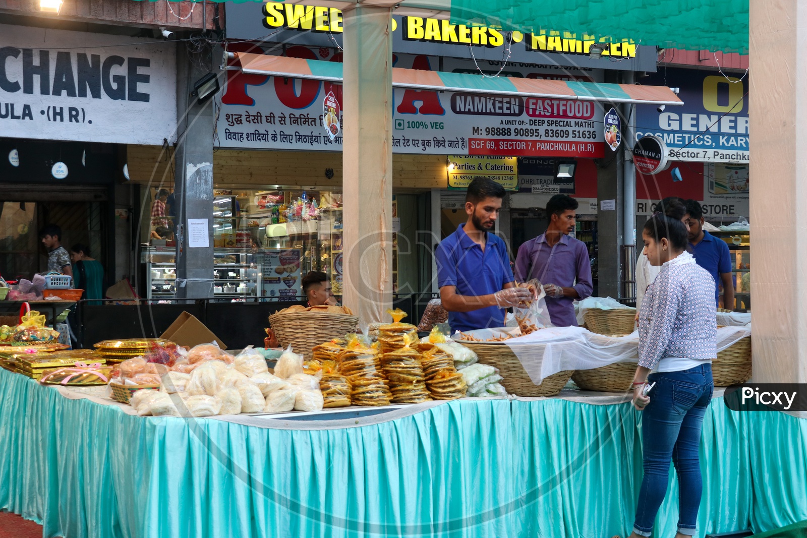 A vendor selling sweet and confectionories at a stall