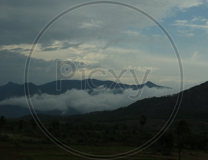 Fog Clouds Over Green Terrain Hill Passes In Munnar