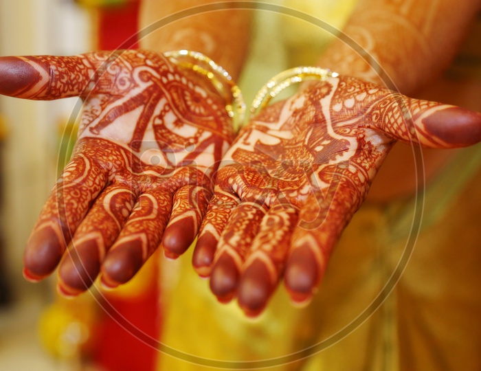 Bride Showing Mehendi designed Hands At a Wedding