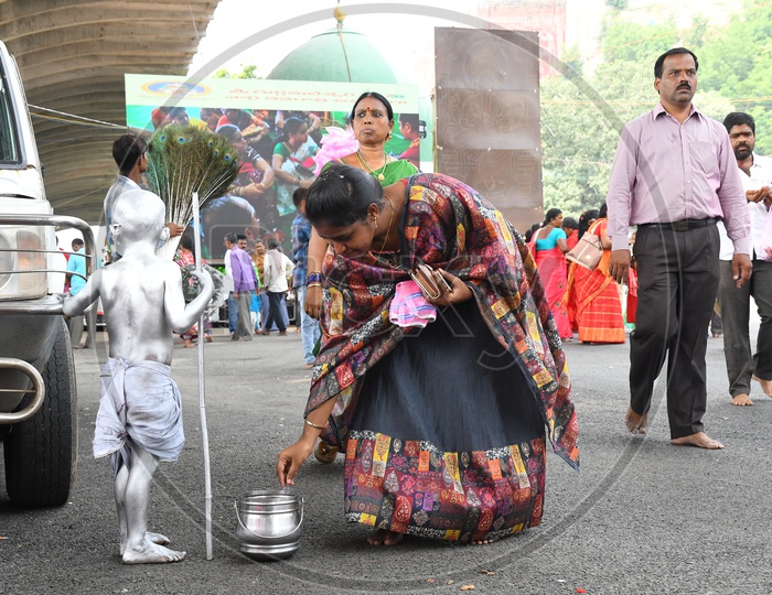 A Kid Painted as Mahatma Gandhi begging on streets
