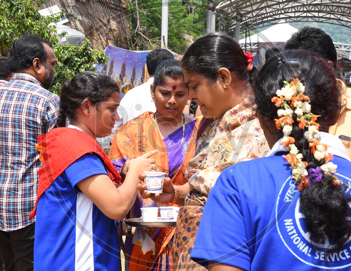 Volunteers giving Butter Milk to Devotees on a Sunny Day