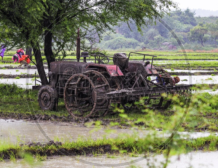 A muddy tractor on a monsoon day