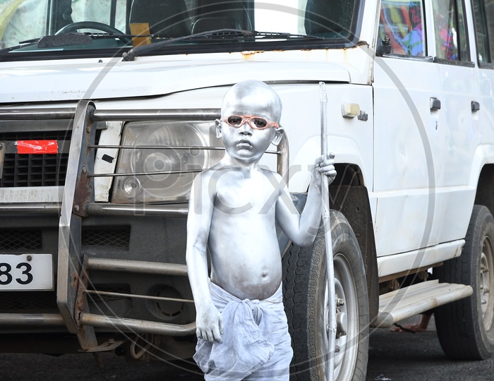A child Begging Painted as Mahatma Gandhi