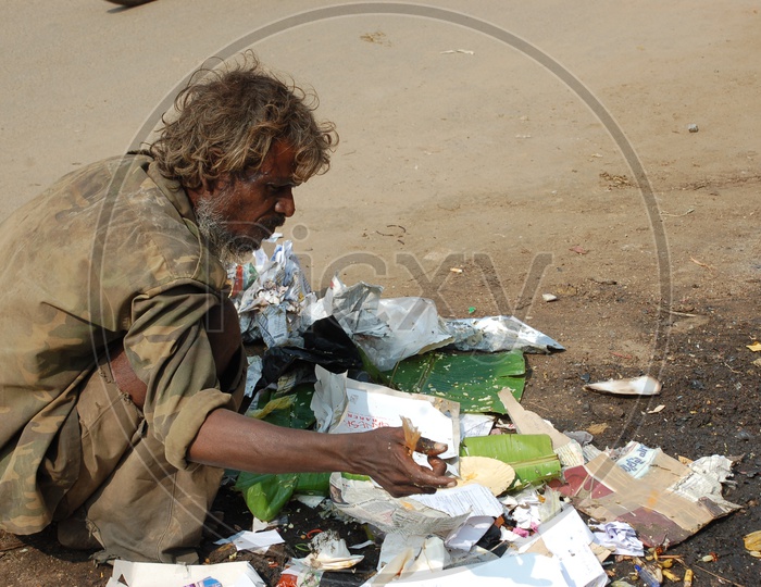 A Beggar Collecting Papers