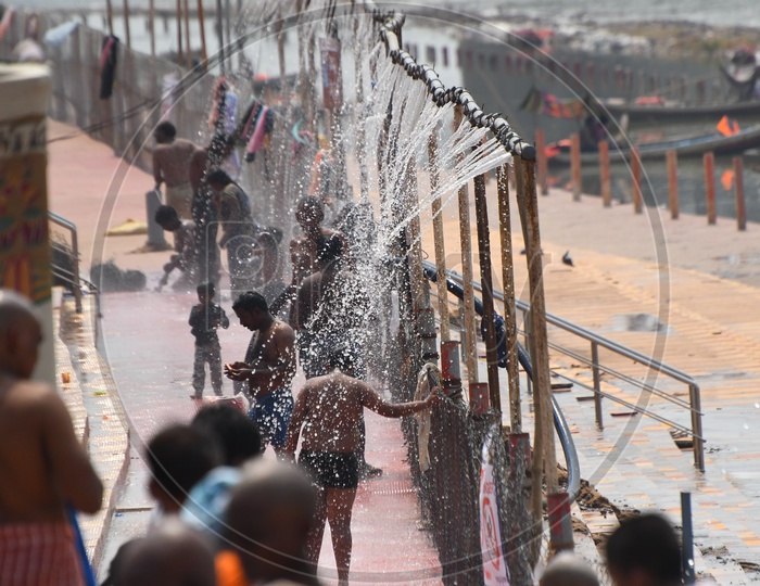 Pilgrims Taking Bath At Showers Arranged At Krishna River Bank During Dussera  Navratri Festivals In Vijayawada