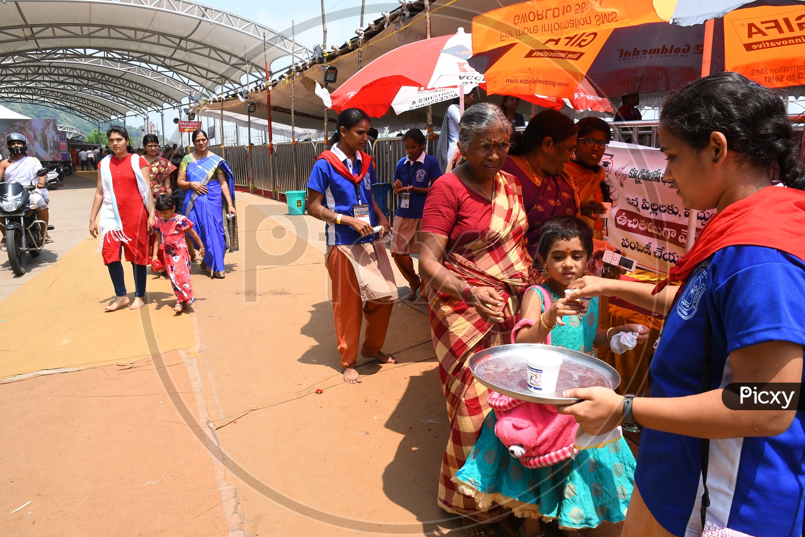 Helping Hands Charitable Trust Volunteers Distributing Milk For Children In Darshan Queue Lines At Kanaka Durga Temple