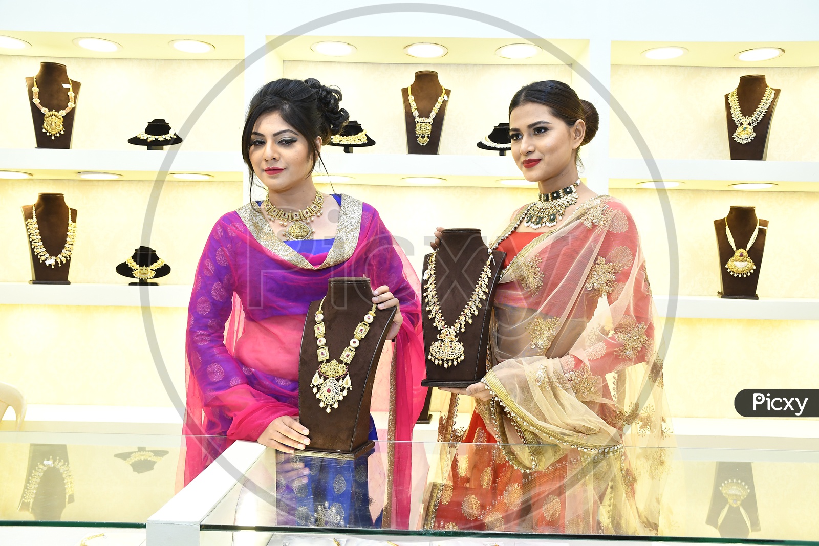 Female Models showcasing the Necklace sets in the Mart
