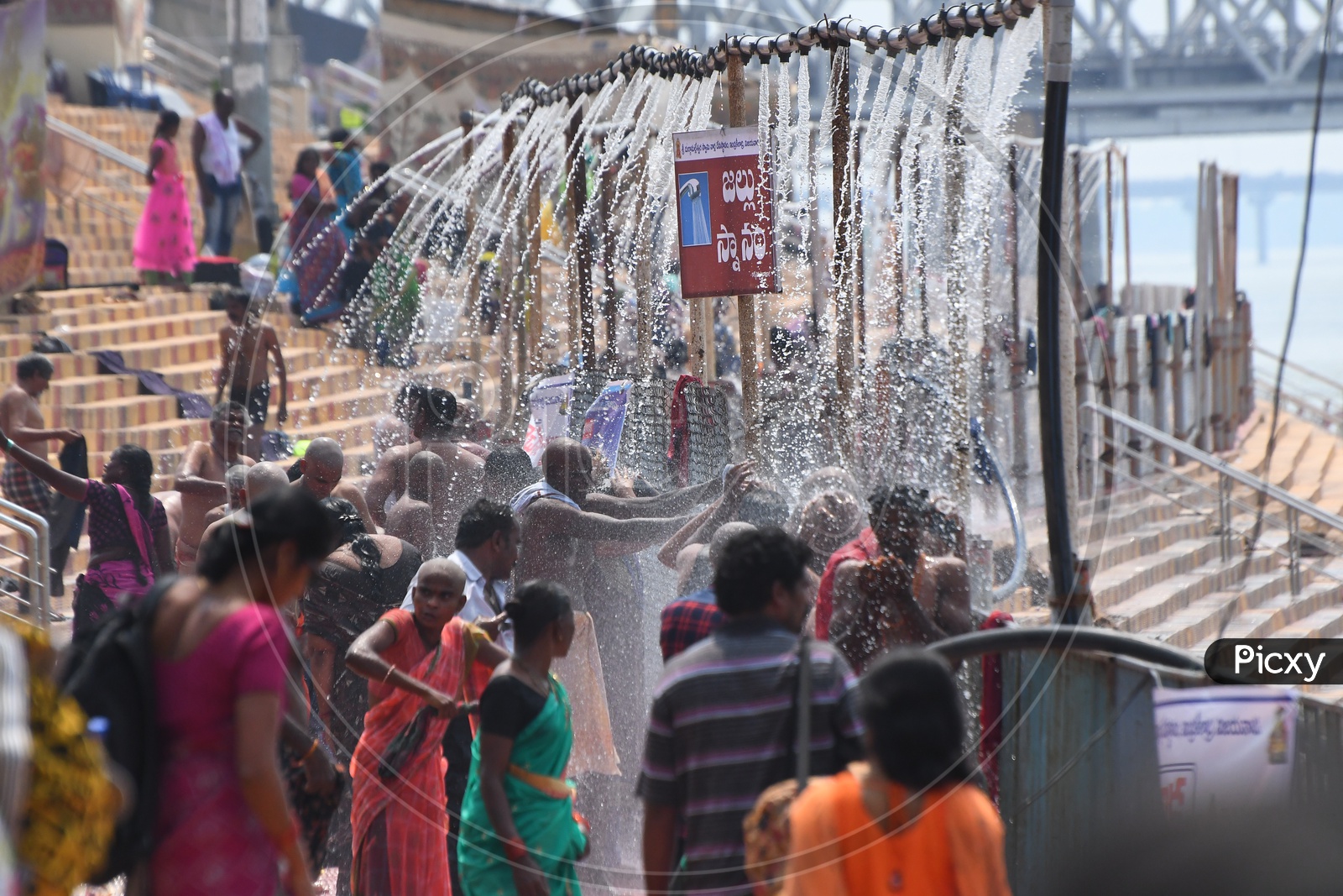 Devotees Taking Bath At Showers Arranged Near Krishna River Bank During Durga Navratri Festivals