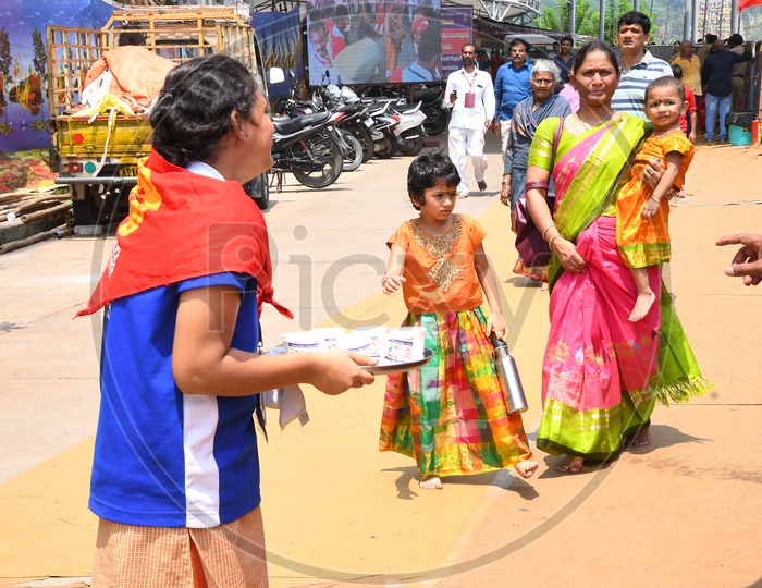 Helping Hands Charitable Trust Volunteers Distributing Milk For Children In Darshan Queue Lines At Kanaka Durga Temple