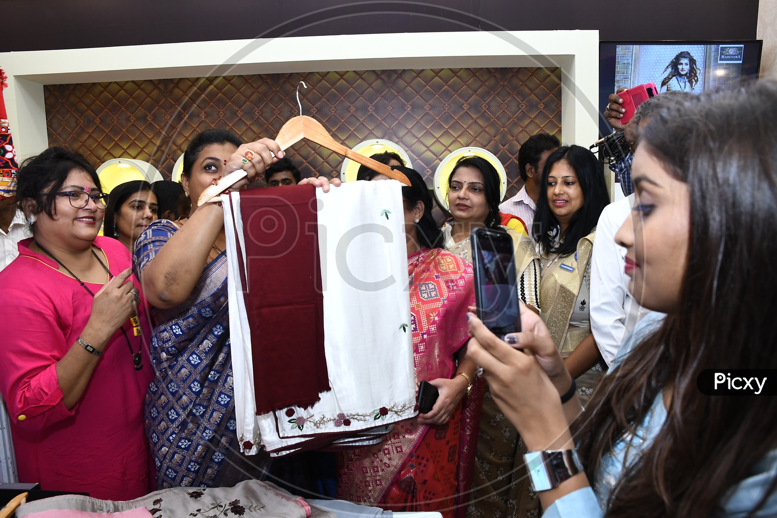 APIIC Chief and Nagari MLA RK Roja holding a saree in the stall