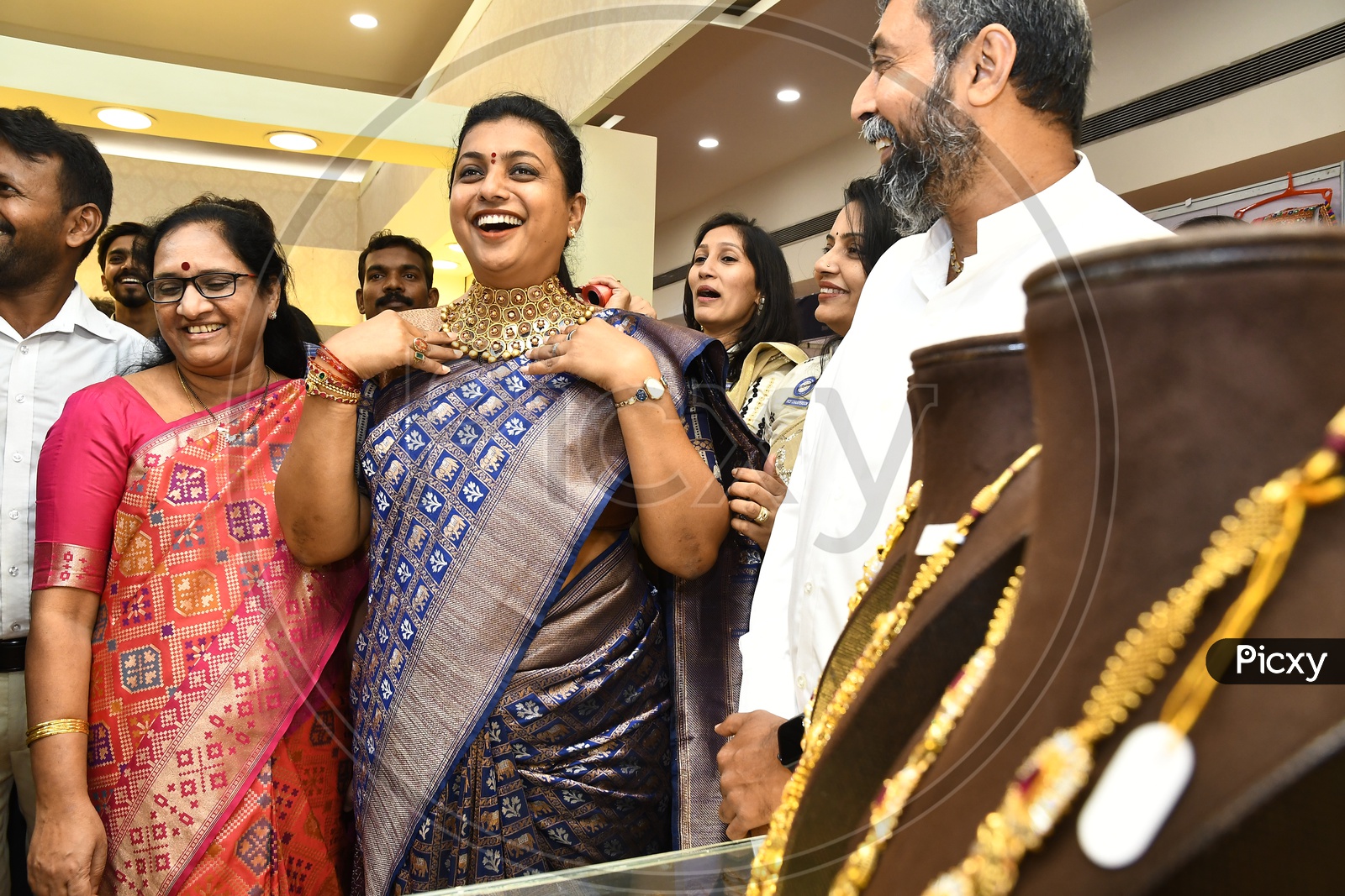 APIIC Chief and Nagari MLA RK Roja trying a heavy necklace