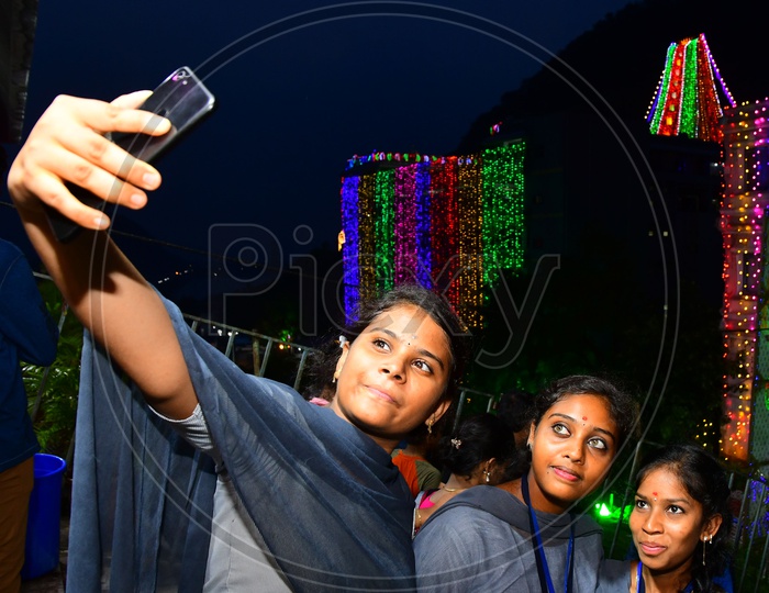 A Group of college girls taking a selfie during night