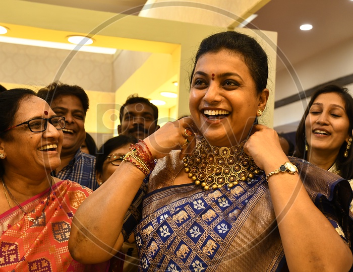 APIIC Chief and Nagari MLA RK Roja smiling along with the other women in the mart