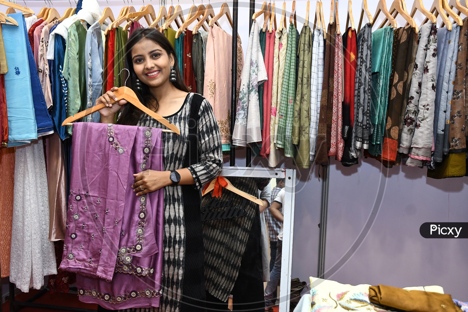 Young Girl showing latest ladies wear in a Cloths Store