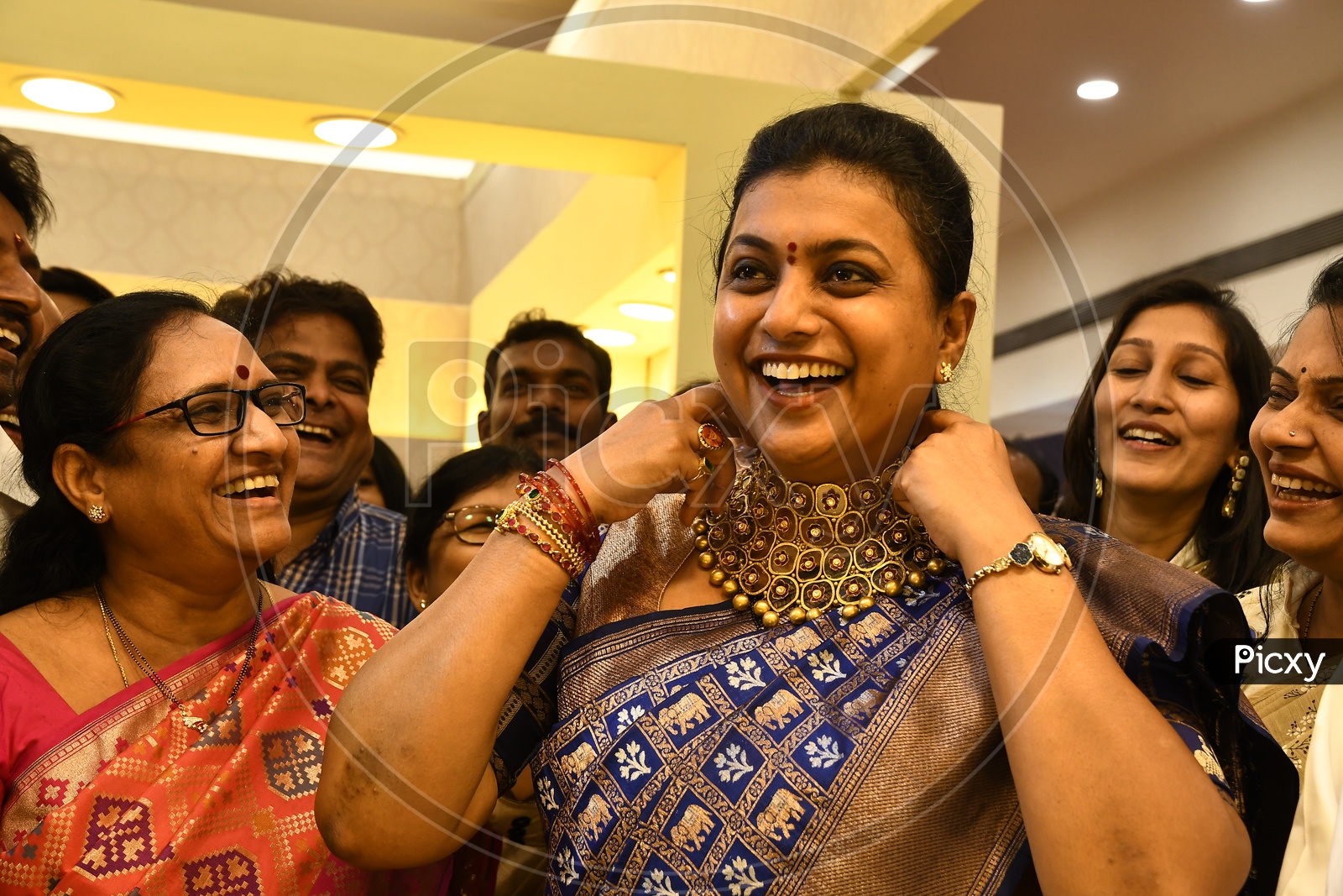 APIIC Chief and Nagari MLA RK Roja smiling along with the other women in the mart