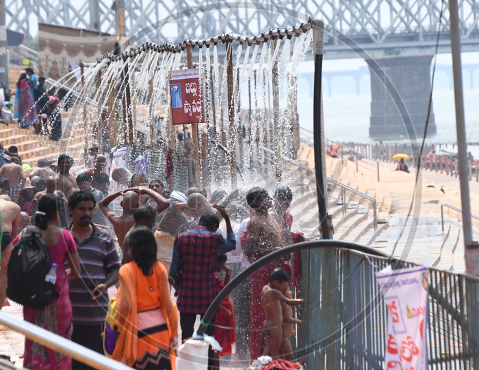 Devotees Taking Bath At Showers Arranged Near Krishna River Bank During Durga Navratri Festivals