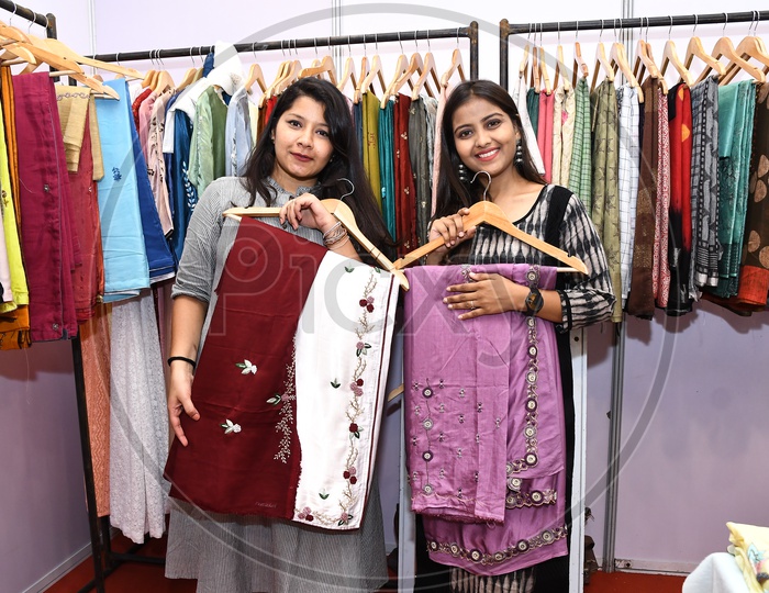 Young Girls showing latest ladies wear in a Cloths Store