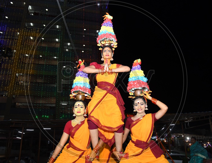 Indian Girls dancing with pots on their heads during Dussehra