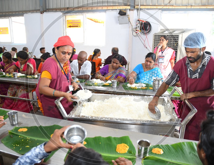 Volunteers Serving Food At Annadaanam Or Food Donation Dining hall  by Hindu God Devastanams