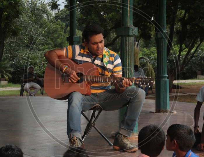 Close up of Indian Man playing Guitar