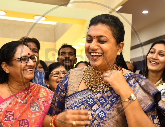 APIIC Chief and Nagari MLA RK Roja smiling wearing the heavy necklace