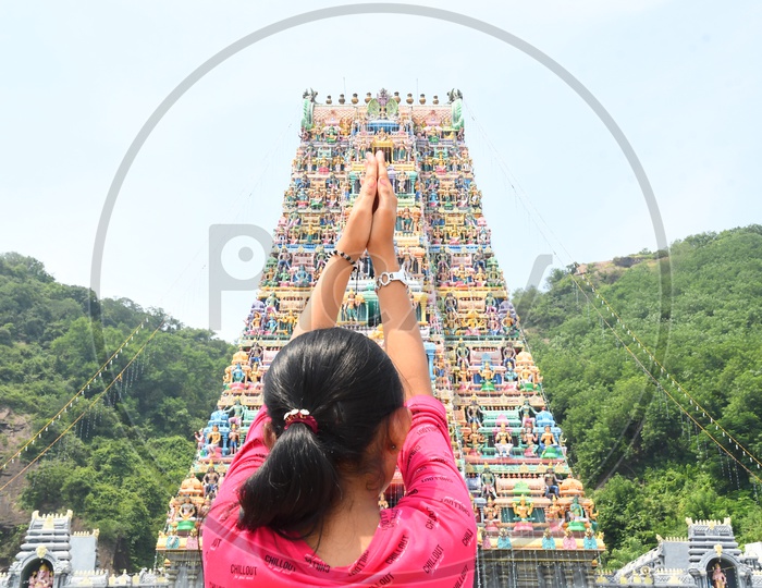 Indian Hindu Girl Praying By Joining Hands At a Temple