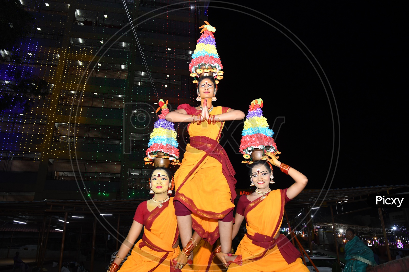 Indian Girls dancing with pots on their heads during Dussehra