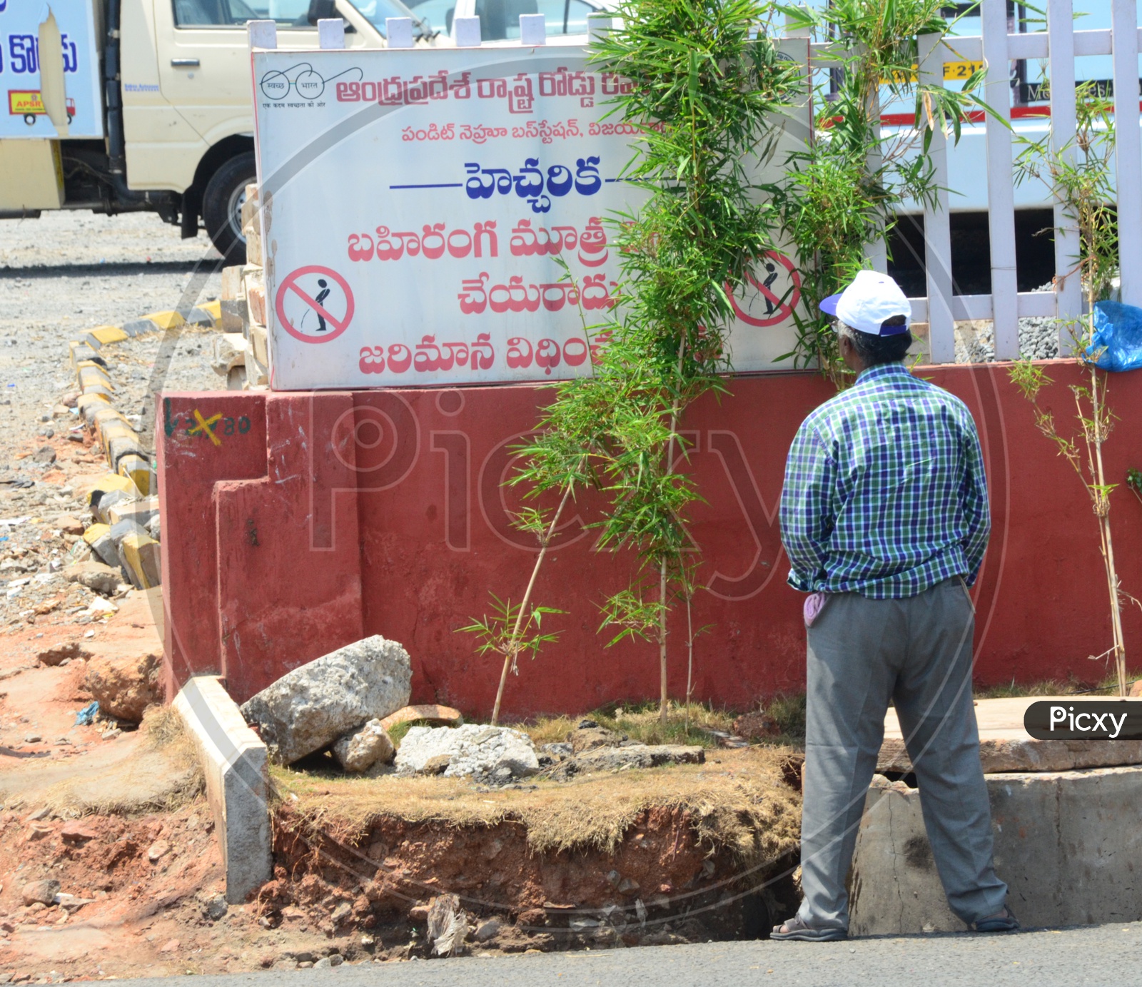 Indian Man Urinating in front of the "No Public Urinating Info Board"