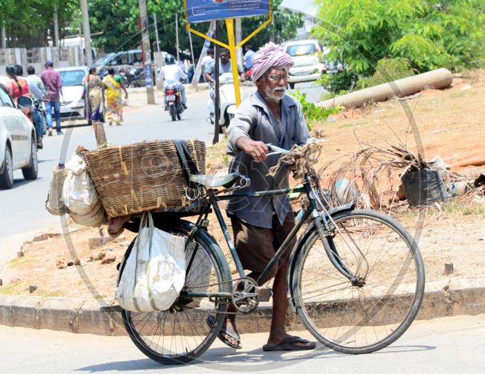 Indian Old Man carrying a basket on the bicycle