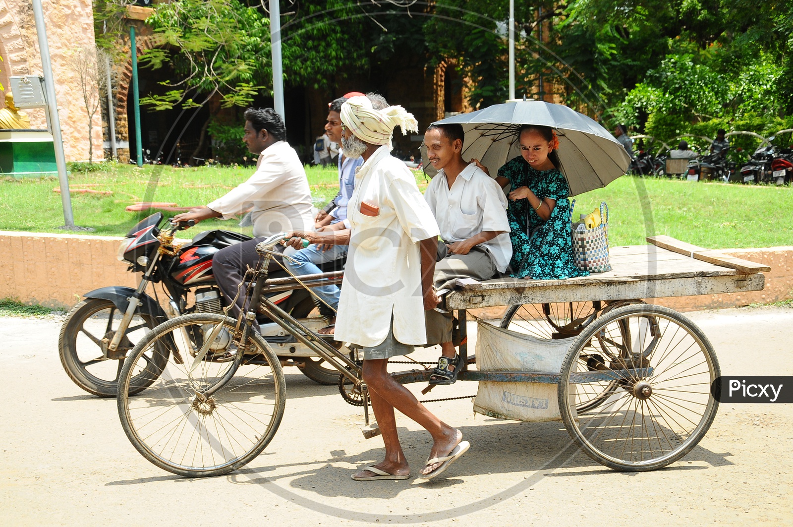 Indian Old Man riding Rickshaw