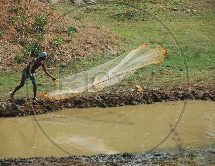 A Lcoal fisherman throwing his cast net to catch fish