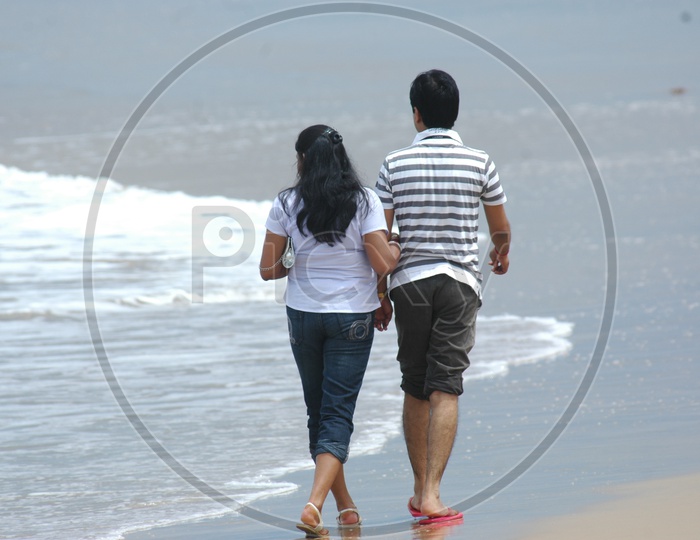 A Couple taking a walk along the beach