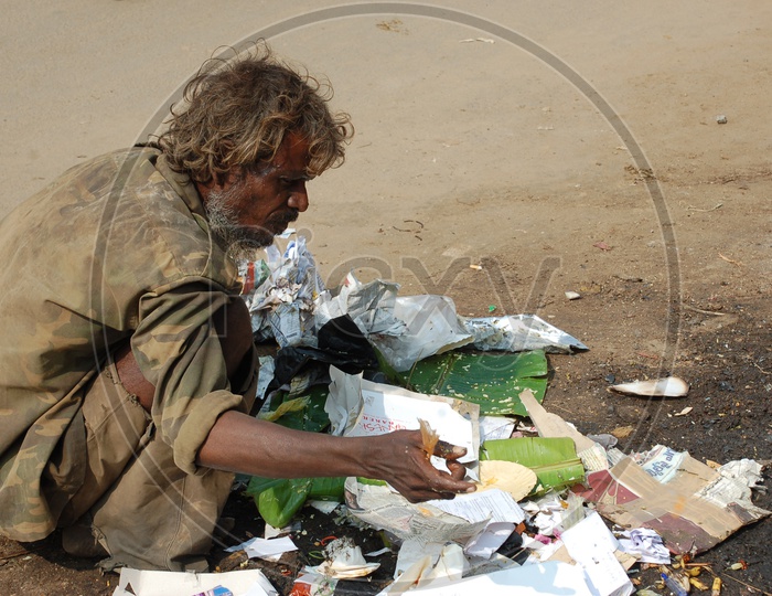 Indian Beggar collecting the Waste on the road