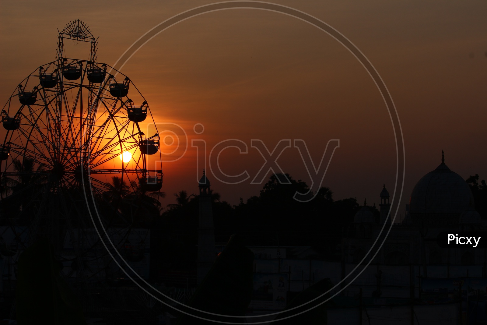 Sunset over a giant wheel
