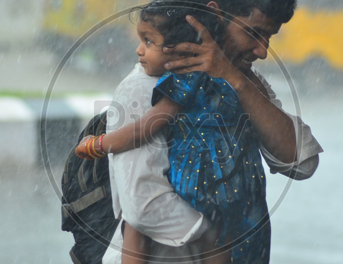 Indian Brother carrying her sister during rains