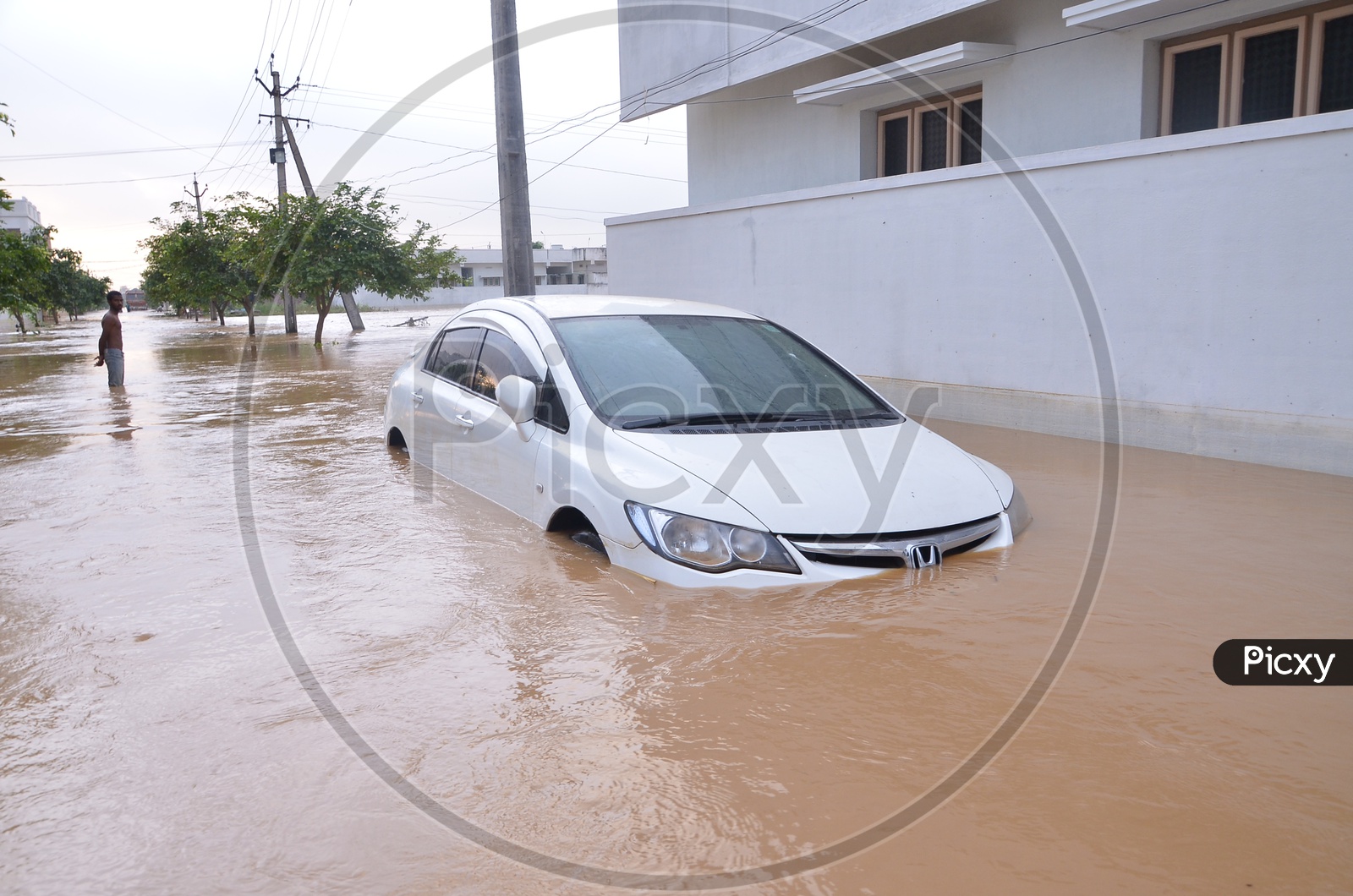 A Car moving in the flood water in Eluru
