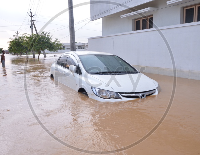 A Car moving in the flood water in Eluru