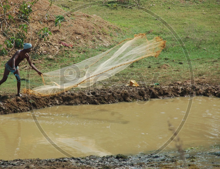 A Local Fisherman throwing cast net