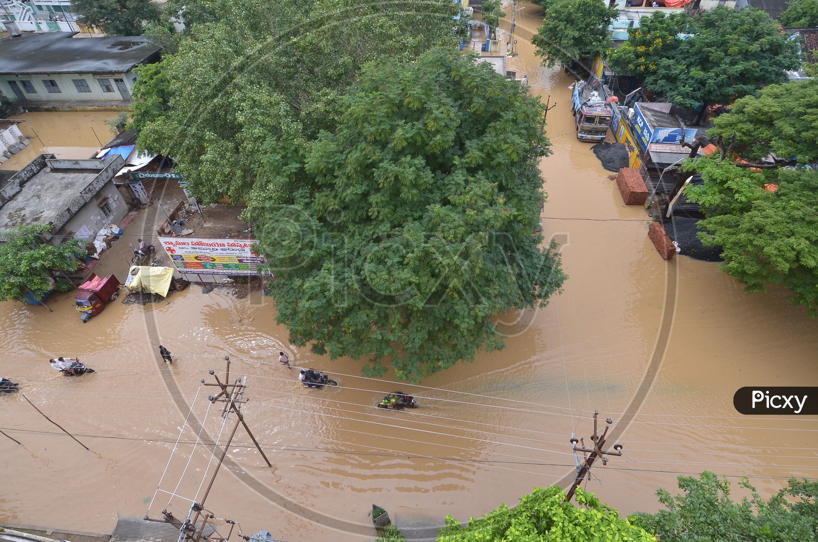 People moving on the flooded roads in Eluru