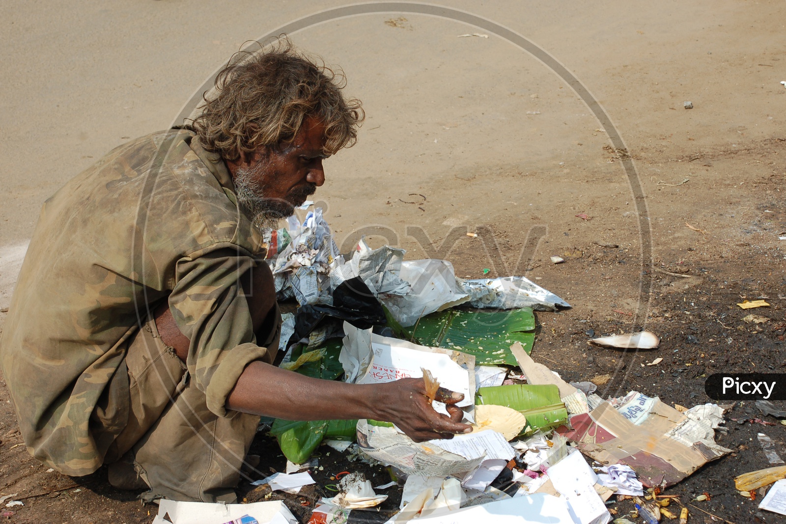 Indian Beggar collecting the Waste on the road