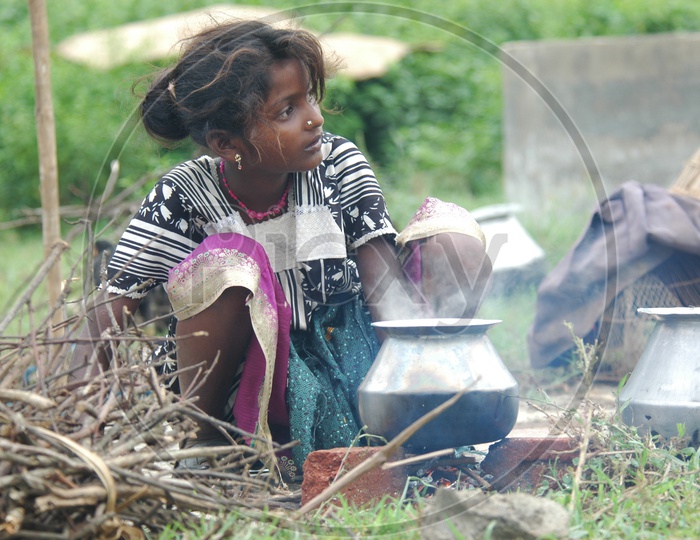 Indian Rural girl child cooking food in traditional style