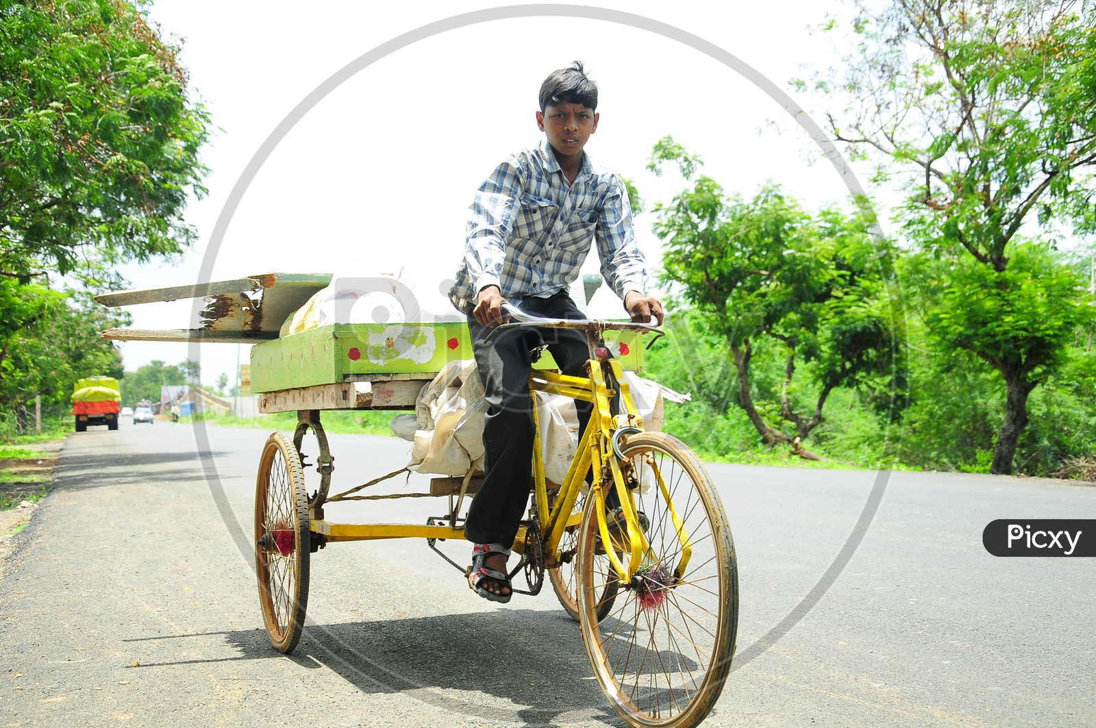 An Indian Street Child riding Trolley Rickshaw