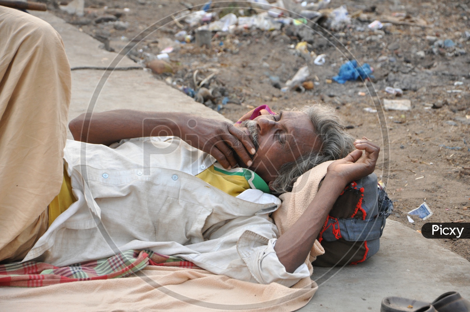 An Indian homeless Old Man sleeping on the footpath