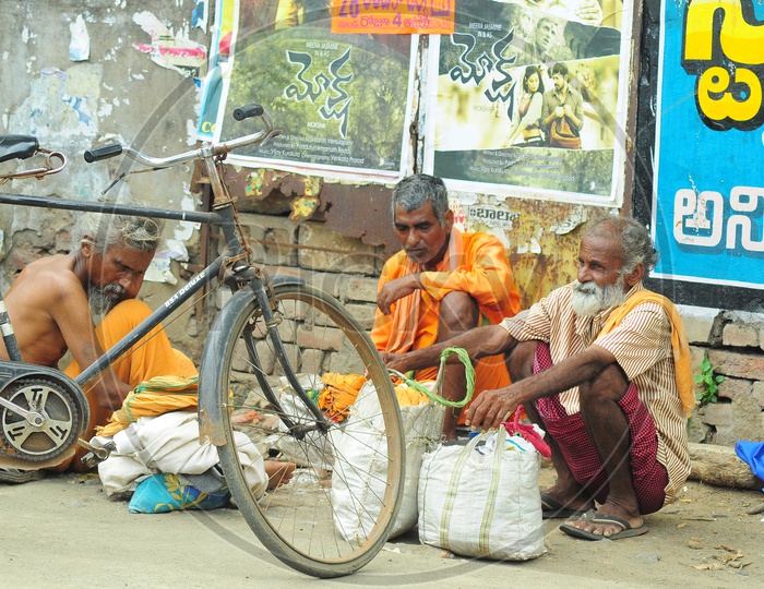 Indian Monks sitting along a bus stand