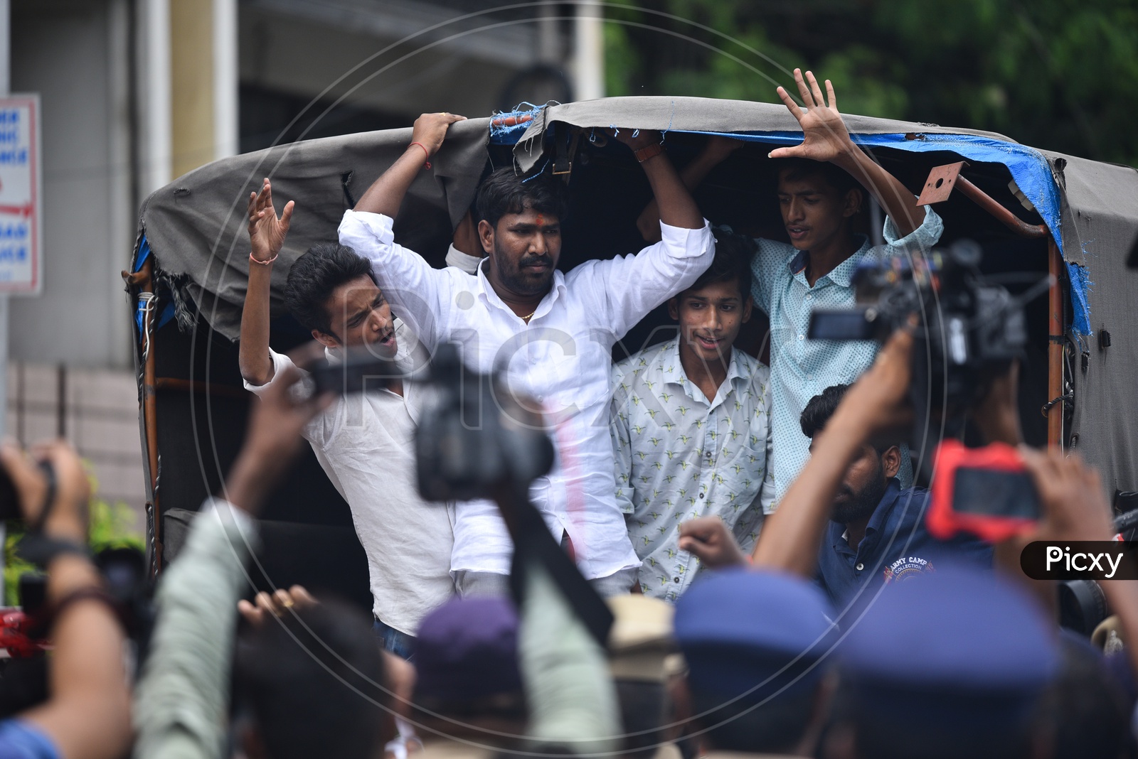 men being detained into a van by Telangana Police as he protests at Pragathi Bhawan Gherao on 21st October,2019