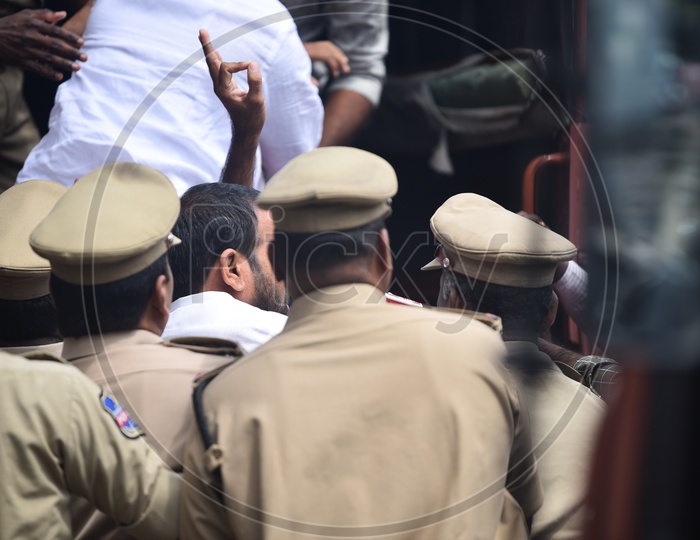 Protestors being carried away by police in separate vans after detaining them as Congress Party called for a  Pragathi Bhawan gherao