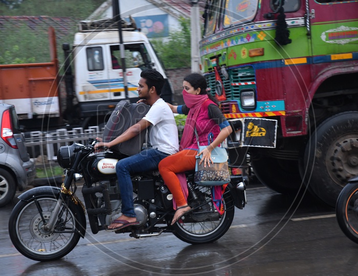 Unidentified People Driving Bike without Helmet