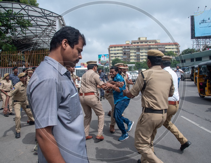 A man being detained by Telangana Police as he protests at Pragathi Bhawan Gherao