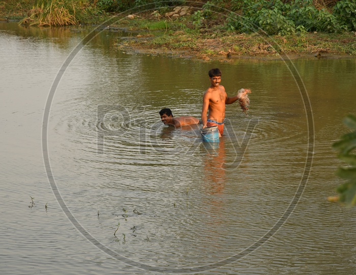 Indian Fishermen with cast nets in the lake