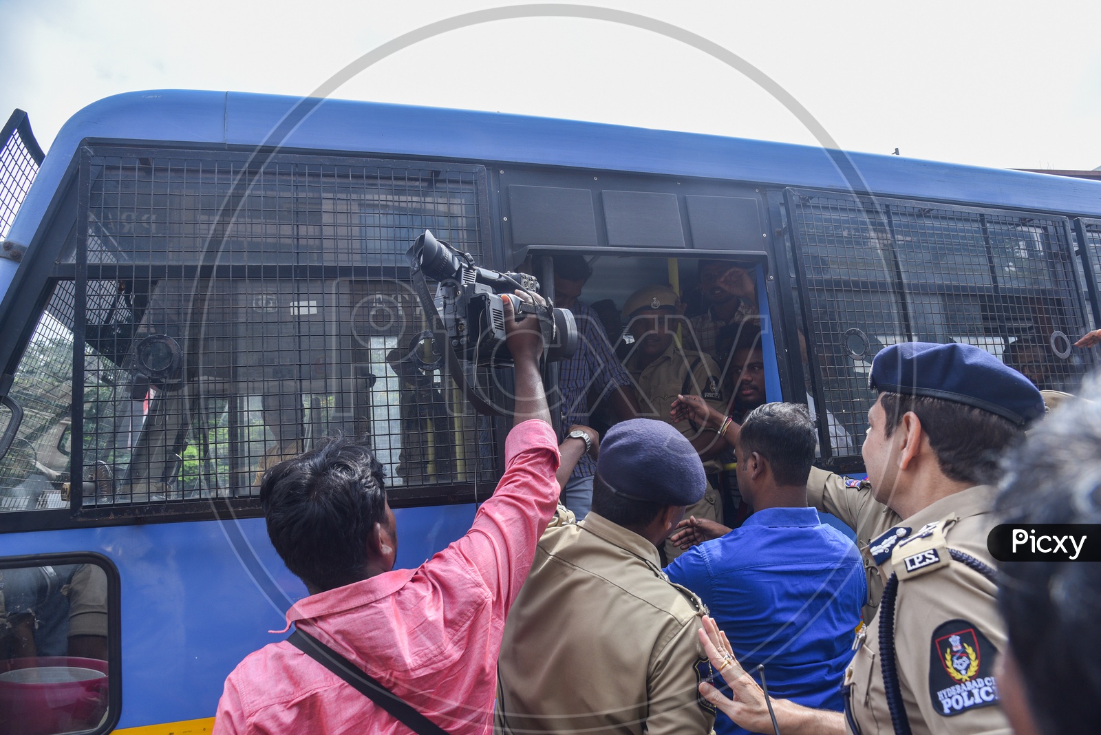 men being carried in a van after detained and arrested  by TS Police